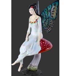 FIGURA HADA SENTADA SOBRE SETA